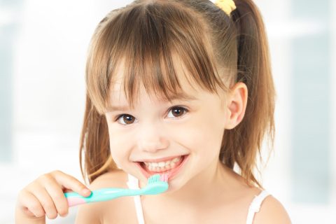 child brushing teeth